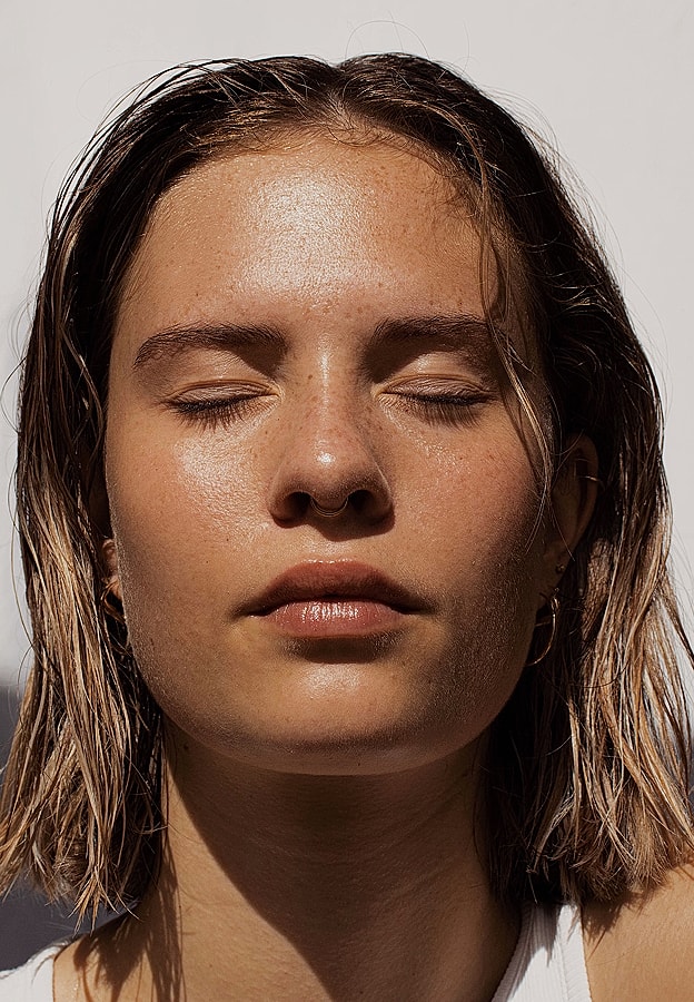 Close-up portrait of a woman with closed eyes.