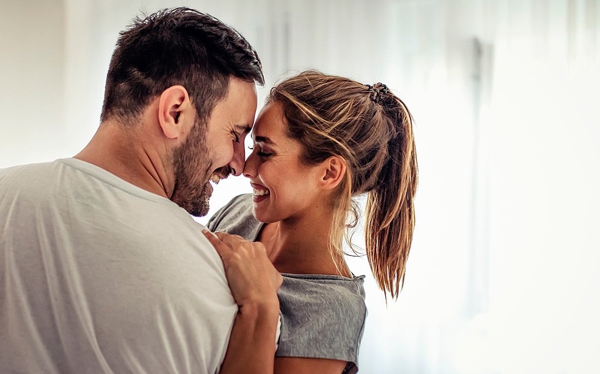 Couple sharing a joyful moment together indoors.