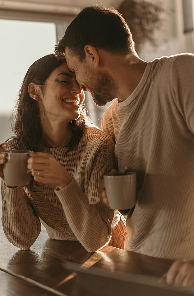 Couple sharing a joyful moment with coffee.