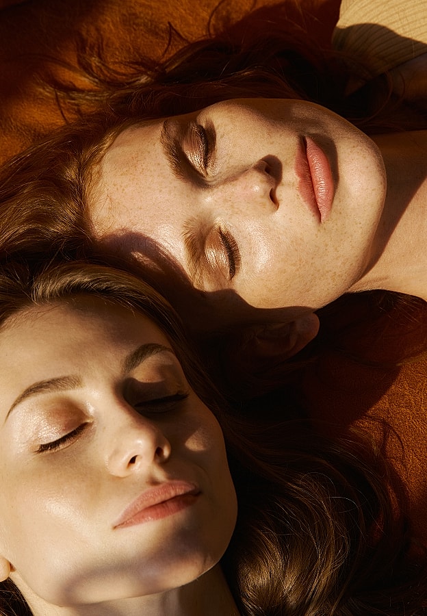 Two women relaxing with closed eyes.